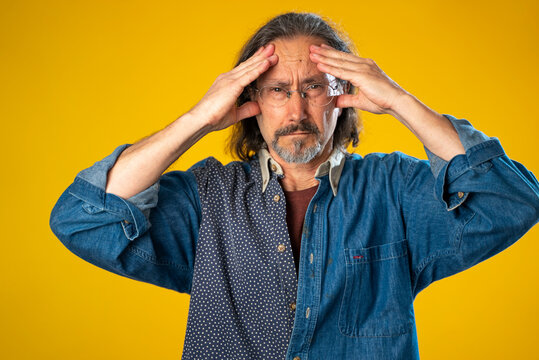 Sick Tired Headache Exhausted Displeased Man 50s 60s Posing Isolated On Yellow Background Studio. People Lifestyle Concept. Put Hands On Head