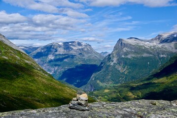 Mountainous landscape in Møre og Romsdal fylke in Norway with a small pyramid of stones in foreground. 