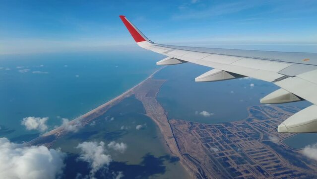 View from airplane flying over sand beach, estuaries and Black sea, Anapa resort, Russia