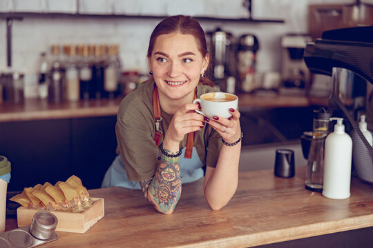 Cheerful Young Woman Barista Working In Coffeehouse