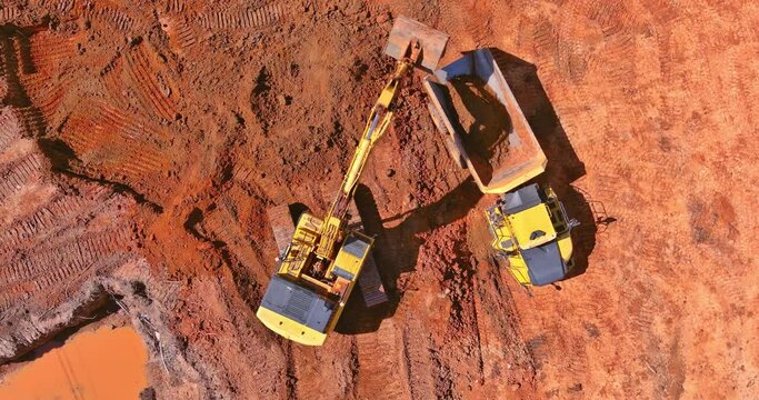 Preparing place to construction site for residential house on tractor bucket is filling a soil in truck