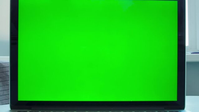 Green screen of laptop. Camera slide