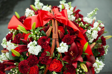 Flowers on memorial. Details of funeral decoration. Bouquet of flowers on grave.