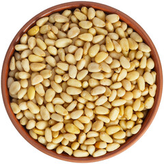 Pine nut in a brown ceramic bowl. Isolated close-up photo of food close up from above on white background.