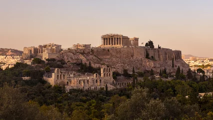 Fotobehang The Acropolis of Athens, Greece, with the Parthenon Temple atop the hill during sunset. © Juan