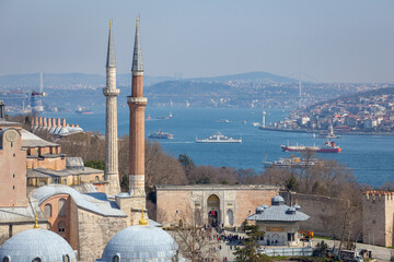 Naklejka premium View of the Topkapi Palace entrance and Fountain Sultan Ahmed III through the Hagia Sophia Mosque with a magnificent view of the Bosphorus in Istanbul, Turkey on Mach 28, 2022.