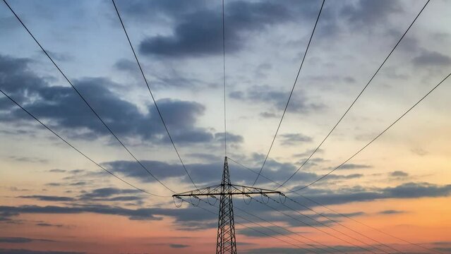 time lapse of power poles with cloudy sky background