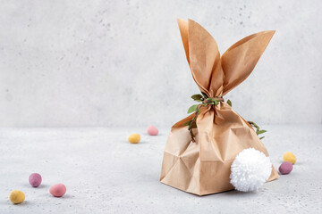 Easter bunny gift bag. Happy Easter holiday background concept. Flat lay minimalism paper bag same bunny or rabbit for gift