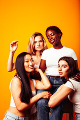 diverse multi nation girls group, teenage friends company cheerful having fun, happy smiling, cute posing on yellow background, lifestyle people concept, african-american, asian and caucasian