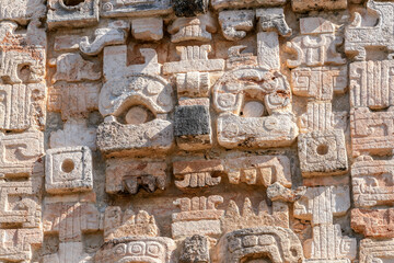 Mayan stone carvings on the wall of the Nunnery Quadrangle at Uxmal archaeological site, Yucatan,...