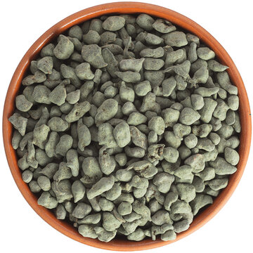 Tea Oolong In Pellets. Chinese Tea Ginseng Ulun Semi-fermented In A Brown Ceramic Bowl Isolated On White Background. Isolated Close-up Photo Of Food Close Up From Above On White Background.