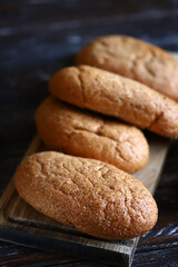 Fresh buns with bran on a wooden surface. Wholemeal bread.