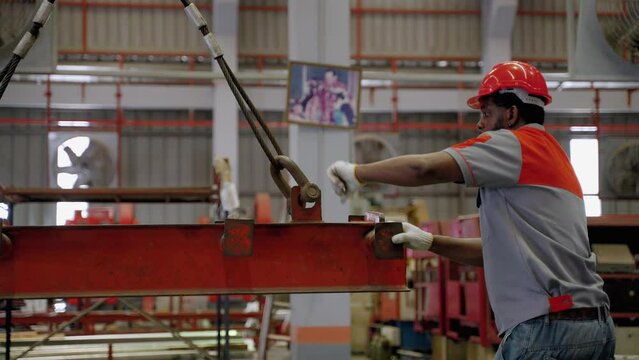 african Americans worker are using hoists and cranes to lift steel or goods to be sorted in industrial plants.
