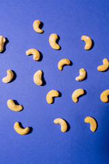 Cashews pattern on a blue background. Nuts creative layout. Top view
