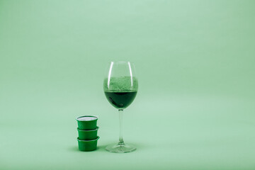 spirulina in a glass on a green background. healthy food