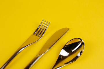 spoon, fork, knife on a yellow background - 496701118