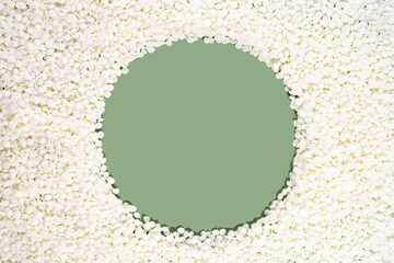 Organic soy wax on green background with copy space for design, text. Top view. frame border of...