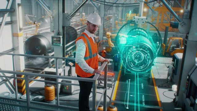 An engineer on a high-tech robotic line for the production of aerospace engines controls information using a modern innovative graphical interface.