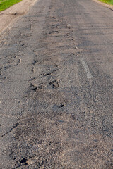 an asphalt road with holes