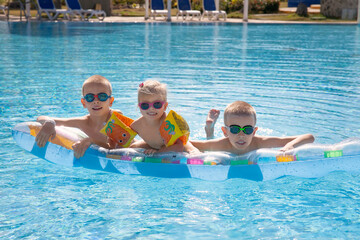 children swim in the pool on vacation in the hotel