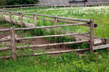 part of a wooden fence for livestock in the village