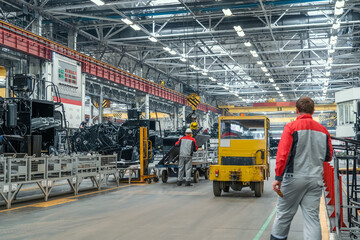 Big industrial factory. Manufacturing of agriculture machines. Workers and technique equipment in workshop.