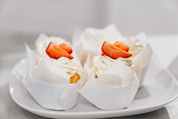 close-up. cupcakes are decorated with white cream and fresh berries
