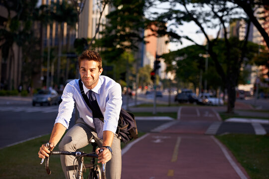No gym membership needed. Shot of a businessman commuting to work with his bicycle.