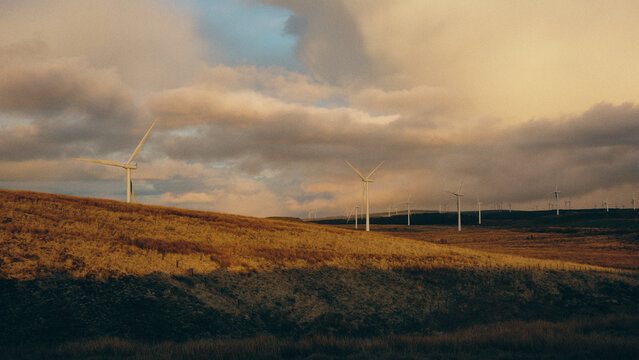 sunset over hills and windmills 