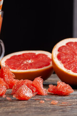 pieces of red grapefruit on a wooden table during meals