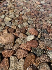 Some stones under the water with ripples