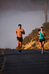 Worry less, run more. Shot of an athletic young couple out for a run in the morning.