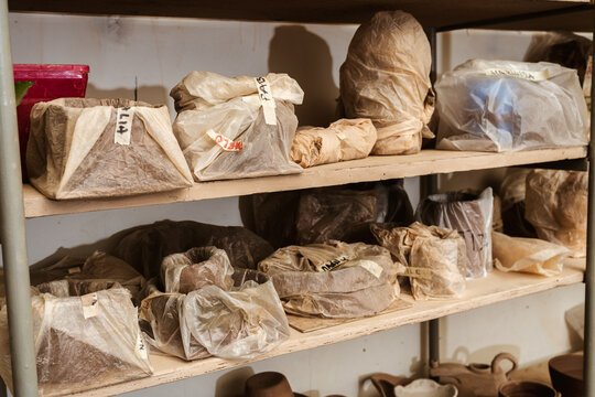 Shelves with packages or bags with pieces of clay until they are fired in the kiln. Crafts in clay and gres.