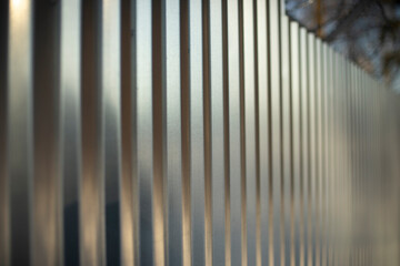 Texture fence. Steel fence of silver color. Horizontal lines.