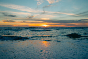 Scenic seascape, sunset over the ocean. Tranquil scene, beautiful sun reflection and stormy ocean