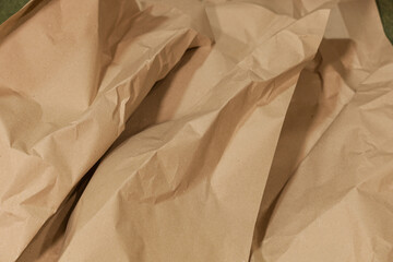 Roughly crumpled beige craft paper, close-up. Art concept, idea for creativity and design. Background or texture