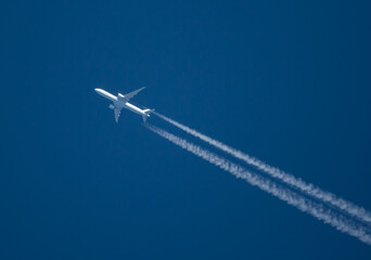 Commercial Airliner at High Altitude with Contrails