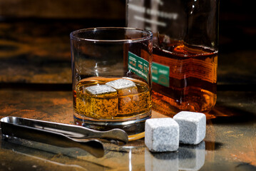 Glass of scotch whiskey and cooling cubes