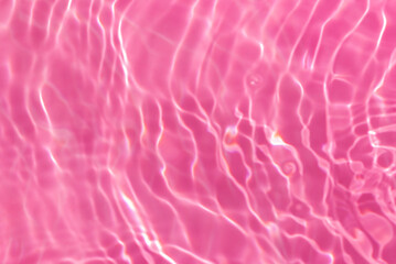 de-focused. Closeup of pink transparent clear calm water surface texture with splashes and bubbles. Trendy abstract summer nature background. for a product, advertising,text space