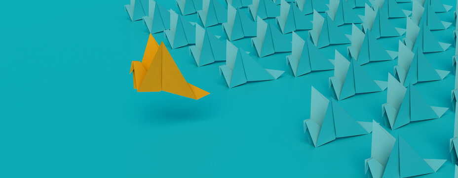 Origami Birds against a Turquoise background. Business concept with Copy Space.