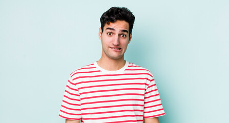 handsome hispanic man looking puzzled and confused, biting lip with a nervous gesture, not knowing...