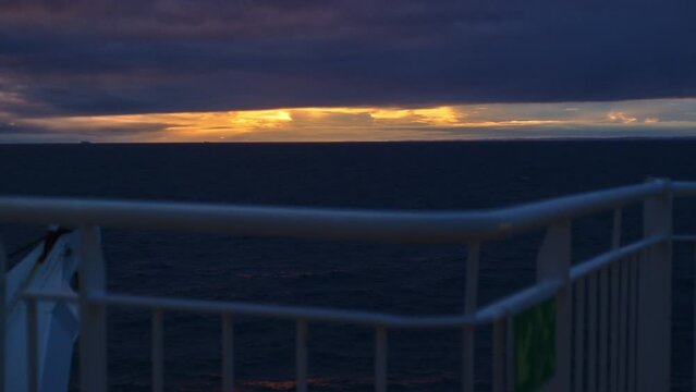 Deck Of Ferry Moving Across Ocean As Sun Sets
