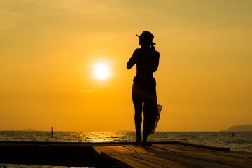 silhouette of two people. silhouette of a woman doing yoga on the beach. silhouette of a woman doing yoga.