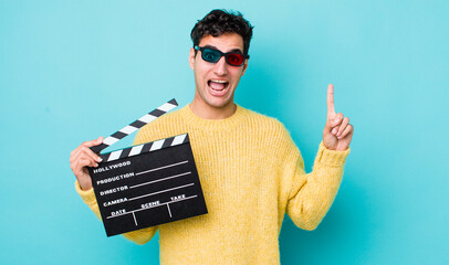 handsome hispanic man feeling like a happy and excited genius after realizing an idea. cinema...