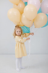 Blonde girl with balloons in the interior