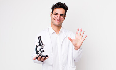 handsome hispanic man smiling and looking friendly, showing number five.. scientist with microscope...