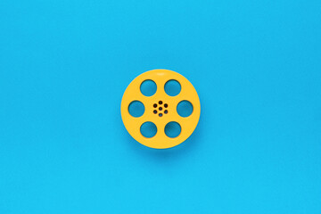 Plastic film reel on a blue background. Flat lay.