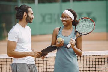 Two tennis players reading a rules before the match