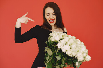 Woman in a black dress with bouquet of roses