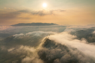 Aerial view fog in the forest and mountains and the transmission towers. Repeater station.
